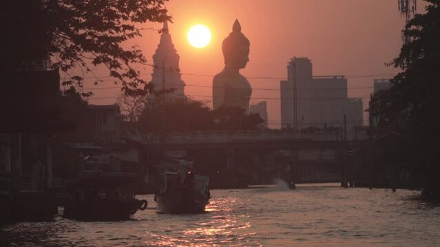 Evening sunset behind the Giant Buddha Statue at Wat Paknam Phasi Charoen in Bangkok, Thailand.