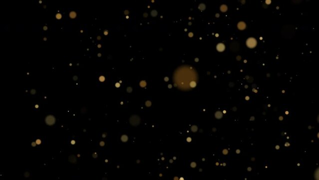 Animation of glittering golden particles on black background.