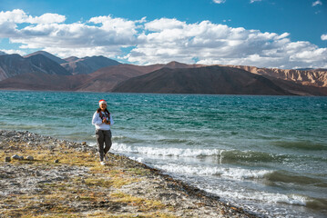 Fototapeta na wymiar Happy Girl travel to Pangong lake, Leh Ladakh, India
