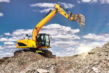 A large yellow crawler excavator moving stone or soil in a quarry. Heavy construction hydraulic equipment. excavation. Rental of construction equipment.