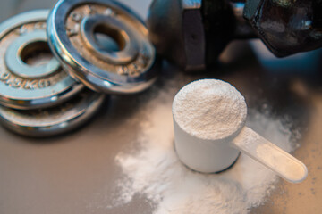 whey protein powder and dumbbell background ,Sports nutrition. Fitness or healthy lifestyle concept.