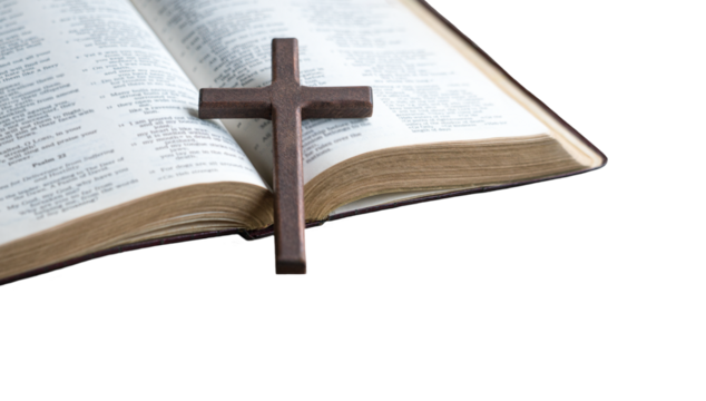 Wooden cross crucifix on top of an open bible. Isolated, transparent background.