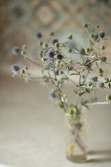 Thorny bouquet in a vase, selective focus, sea holly bouquet, concept of difficult person defending with thorns