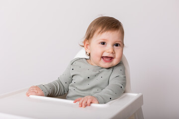 cute baby sitting in high chair, card, banner, space for text