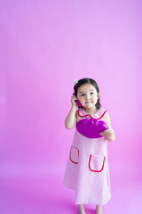 Pretty little girl playing with pretend plastic phone. 