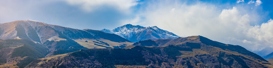 Fototapeta na wymiar Panorama view of mountains covered with snow in Kyrgyzstan