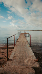 Obraz premium Old pier on famous lake Issyk-Kul in Kyrgyzstan on a peaceful morning