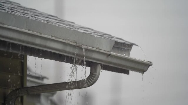 Roof Gutters Overflowing During a Heavy Rain Storm 