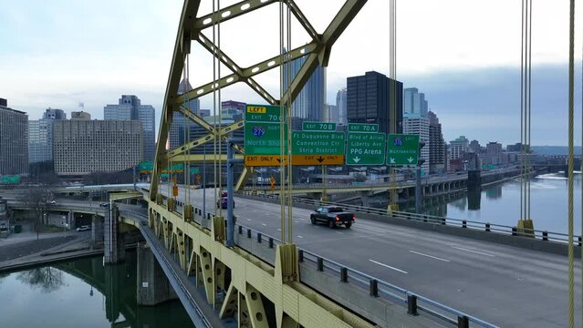 Fort Pitt Bridge in Pittsburgh PA. Aerial shot of cars driving on famous yellow steel bridge.