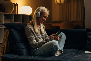 Beautiful woman is chatting on the phone and listening to music