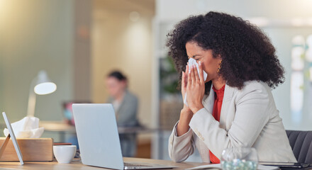Sick businesswoman blowing nose with a tissue and suffering from flu virus or sinuses while working...