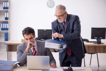 Two male colleagues working in the office