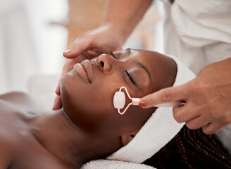 Face roller, spa and black woman for massage, wellness and skincare cosmetics at relaxing salon. Beauty, facial and beautician with rose tool for healthy dermatology, crystal stone and aesthetic glow