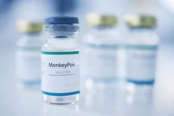 Monkeypox vaccine, backgrounds and medicine vial for protection, safety and healthcare risk. Closeup, liquid bottle and virus immunity of medical drugs, wellness and pharmaceutical science research