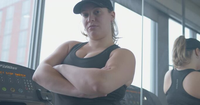 Medium Tilt Up Slowmo of a Young and Confident Woman at the Gym