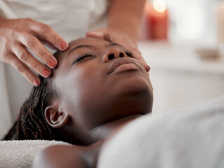 Black woman, face massage and luxury spa treatment of a young female ready for facial. Skincare,...