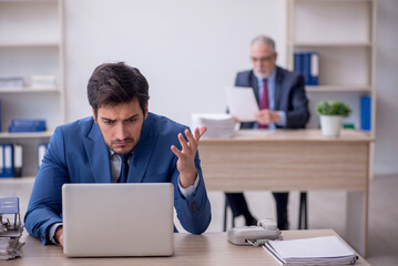 Naklejka premium Two male colleagues working in the office
