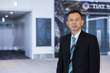 Asian middle-class businessman heading for an overseas business trip in the airport lobby.