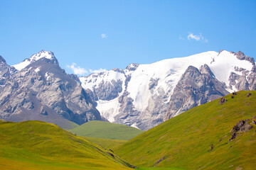 Beautiful nature of rocky mountains and peaks with glaciers. Unusual landscape of nature. Rocks on the background of the sky with clouds. Bad weather cyclone, rainy season, foggy day.