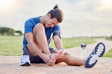 Fitness, sports injury and foot pain with man in park for muscle spasm, inflammation and joint...