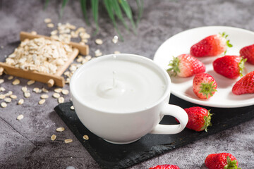 breakfast with milk and strawberries on table