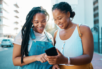 African woman friends with smartphone in urban city reading social media post, check location on...