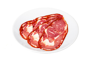 Obraz premium Beef ribeye pastrami isolated on white background. Dried Turkish bacon slices in plate. Traditional Turkish delicacies