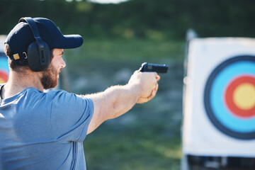 Man, firearm training and target for outdoor challenge, goals and aim for police, army or security academy. Shooting expert, pistol or gun for sport, safety and combat exercise in nature with vision - obrazy, fototapety, plakaty