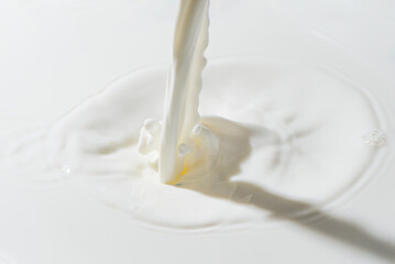 splash of milk or dairy, pouring milk into milk background