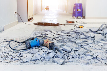 Jack-hammer drilling drill machine hand tool on rough floor. Construction working industry tools...
