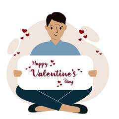 A man sits cross-legged and holds a large card with a congratulation for saint valentine.