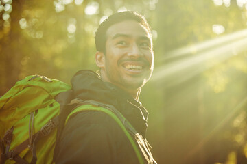 Man, backpacker or hiker in sunshine forest, trekking woods or nature trees in adventure, morning...