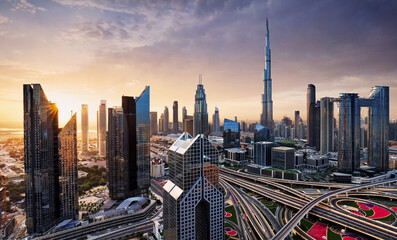 Dramatic sunrise over Dubai skyline panorama with Burj Khalifa and luxury skyscrapers, United Arab...