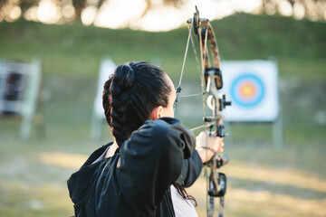 Archery, shooting range and target for sports training with a woman outdoor for bow practice....
