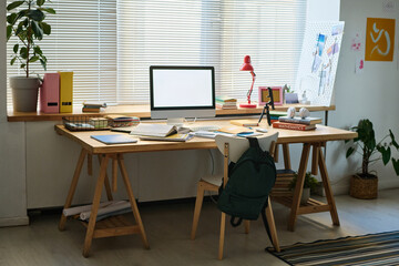 Horizontal image of workplace of schoolchild with computer monitor on it in the room