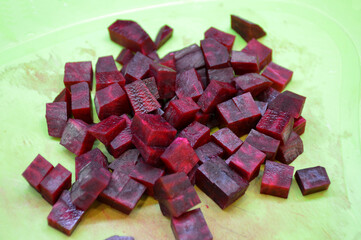 diced red beets on a green board. ingredient for vegetable salad or as a side dish to a dish. healthy diet food