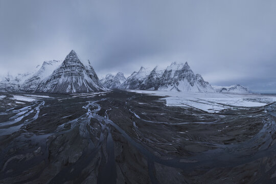 River and wetlands in snowy valley mountain