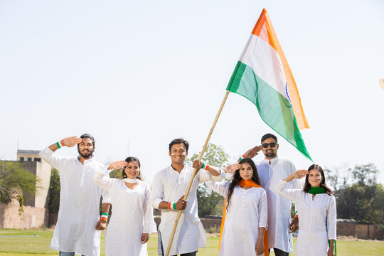 Group of  proud young people wearing white dress holding indian flag celebrate Independence day or Republic day. of india, 15 August, 26 January. 