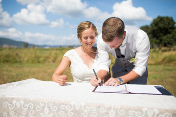 Bride and groom signing marriage license, Abbotsford, British Columbia, Canada
