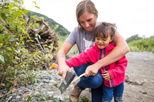 Toddler helping mother make roasting stick