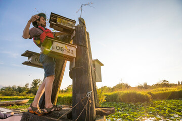 A volunteer cleans  a bird nesting box, Burnaby Lake, British Columbia.