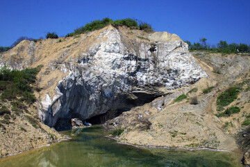 Salt mountain in Romania and a small lake.