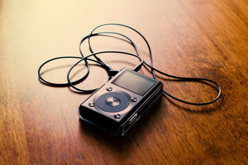 Music mp3 player on a wooden desk.