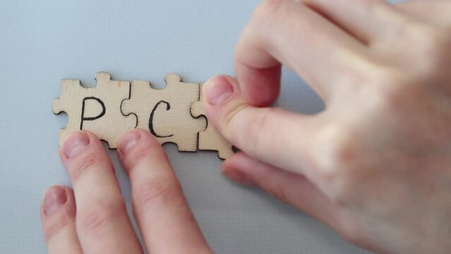 Polycystic Ovarian Syndrome. Hand Writing PCOS on wooden puzzles.