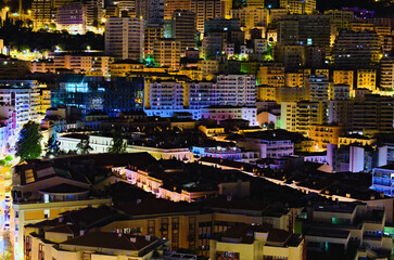 Aerial nightlight landscape of residential buildings in Monaco. Illuminated colorful buildings. Principality of Monaco, buildings, downtown, French Riviera