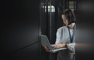 Woman with laptop, datacenter and information technology, engineer and server room with software...