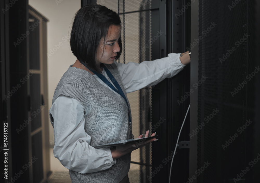 Aufkleber Tablet, server room and engineering with a programmer asian woman at work on a computer mainframe. Software, database and information technology with a female coder working alone on a cyber network