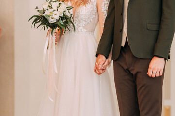 The newlyweds are holding hands at a festive ceremony 4452.