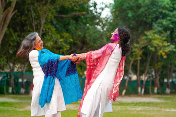 Two Indian woman playing fugadi and celebrate holi festival. fugadi is culture game of hinduism.