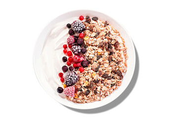 Isolated Muesli bowl or granola bowl with yogurt and  red berries. Healthy breakfast, top view....